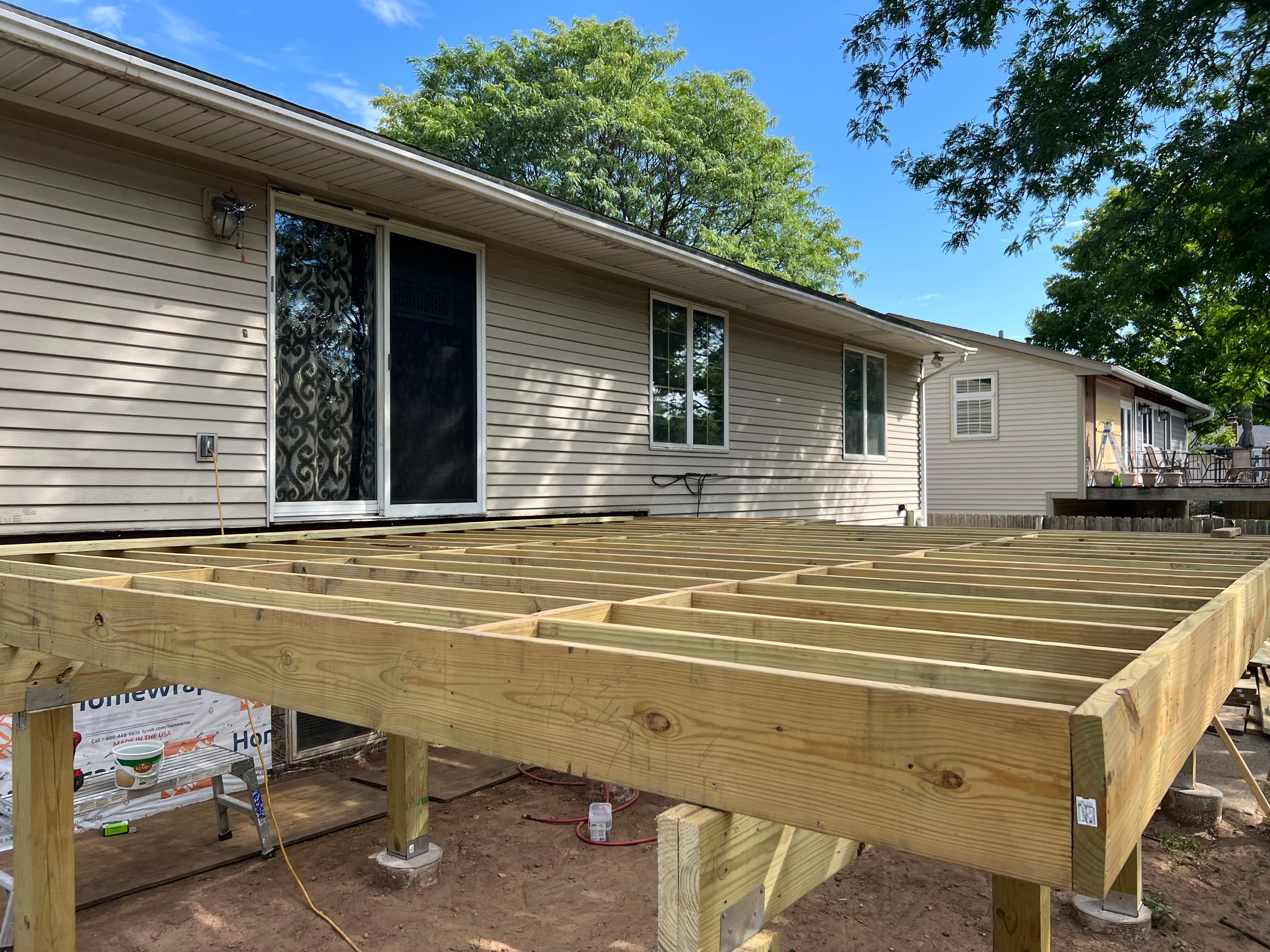 Picture of a wood deck being built in the backyard of a residential minnesota home 